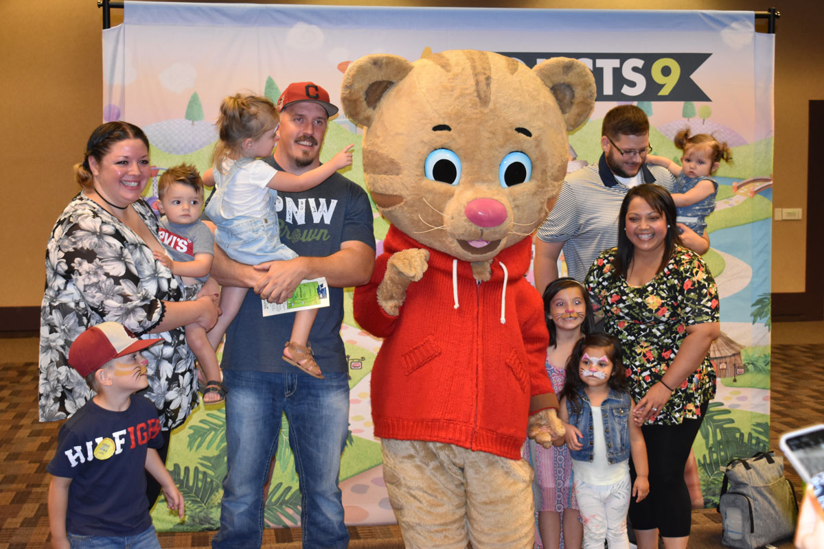 Families posing with Daniel Tiger