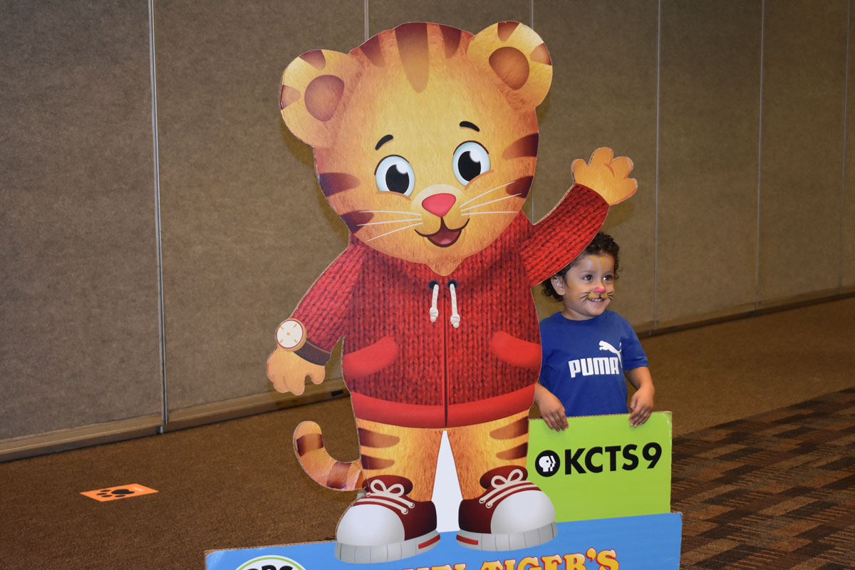 Child posing with Daniel Tiger cutout
