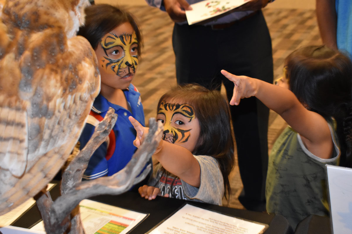 Children with facepaint pointing